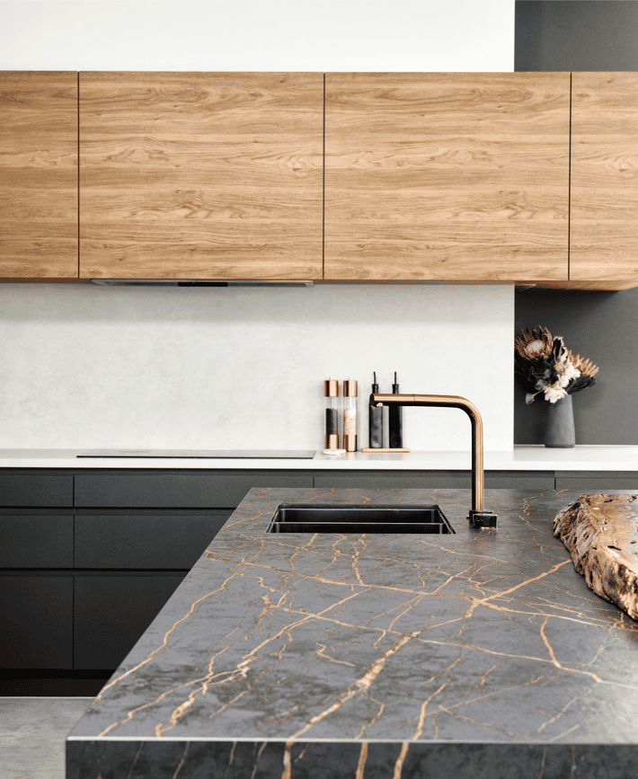 Contemporary custom home kitchen in Marmion featuring timber cabinetry, stone splashback and minimalist detailing.