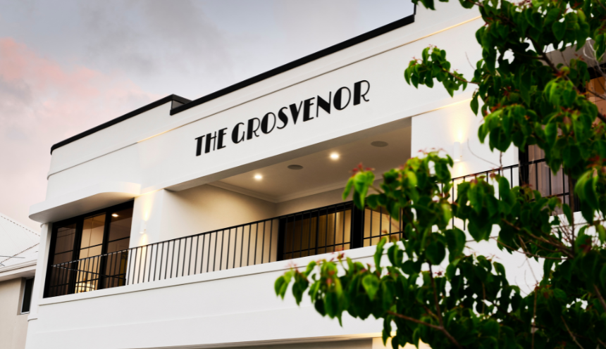 Exterior architectural detail of the Grosvenor custom home featuring curved white walls and the home's name.
