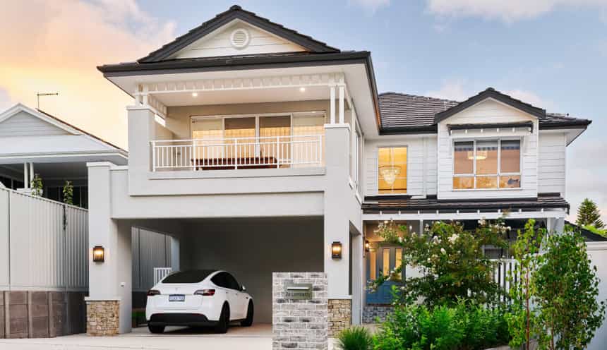 Two-storey custom home on Lombardy Street featuring traditional architectural detailing, weatherboard cladding and a covered balcony.
