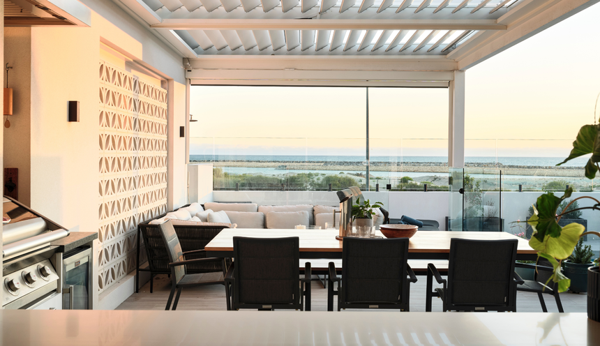 Coastal kitchen and alfresco area featuring expansive ocean views, outdoor seating and timber ceiling detailing in Ocean Reef home.