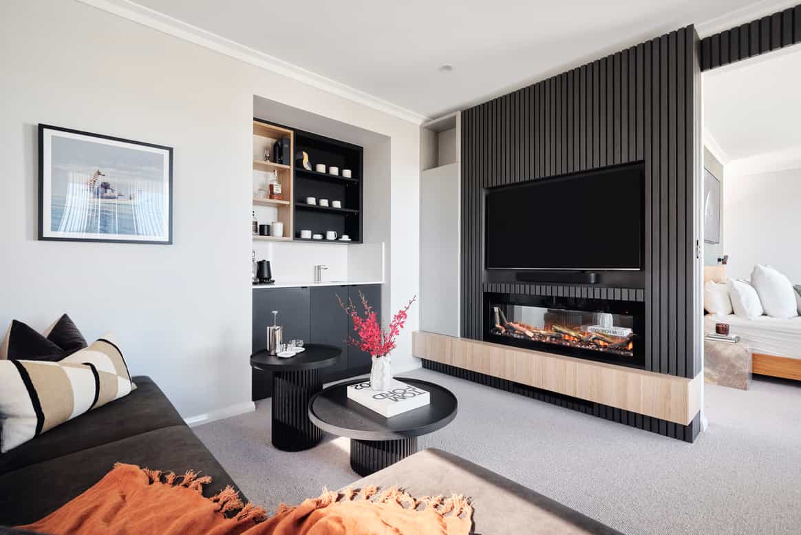 Custom home living room featuring dark timber wall panelling, built-in entertainment cabinetry and contemporary furnishings.