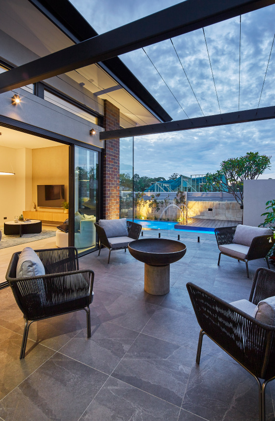 Covered alfresco dining area at Redmond Street featuring a swimming pool, outdoor furniture and landscaped garden views.