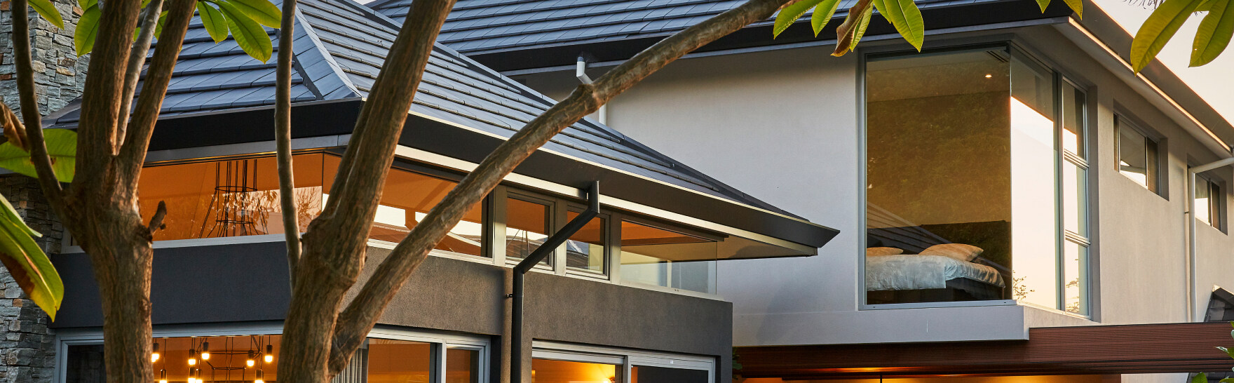 Close-up of custom home roof detailing featuring exposed timber beams and architectural joinery.