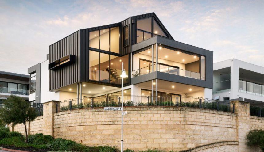 A custom modern home on a corner block towering over the street with interesting industrial elements by Trendsetter Homes.