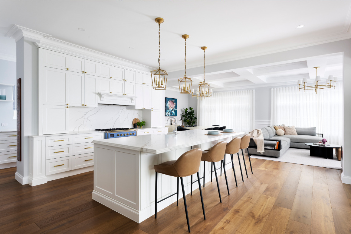 A luxury white and gold kitchen with white island countertop inside a luxury custom built home